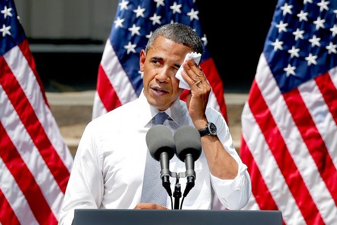President Barack Obama wipes perspiration from his face as he speaks about climate change at Georgetown University in Washington, Tuesday, June 25, 2013. The president is proposing sweeping steps to limit heat-trapping pollution from coal-fired power plants and to boost renewable energy production on federal property, resorting to his executive powers to tackle climate change and sidestepping the partisan gridlock in Congress. (AP Photo/Charles Dharapak)