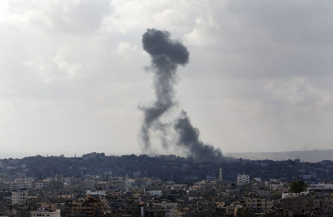 Smoke from an Israeli strike rises over the Gaza Strip, Friday, July 25, 2014. An Israeli defense official says the Israeli Security Cabinet is meeting to discuss international cease-fire efforts, but also the option of expanding its forces' eight-day-old ground operation in Gaza.