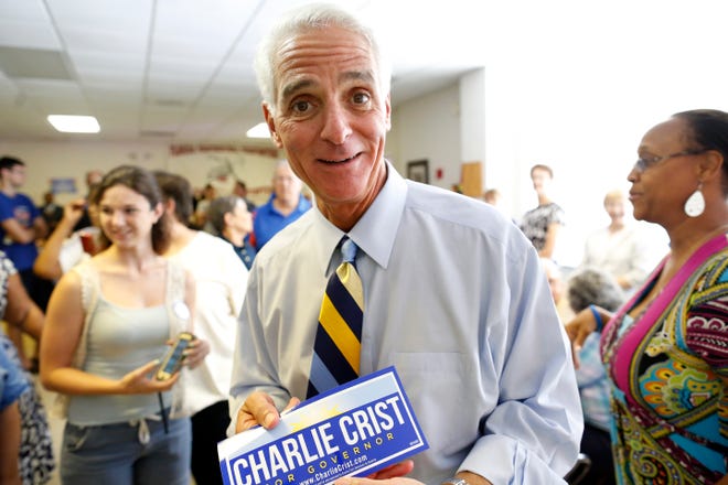 Former Florida Governor and current gubernatorial candidate Charlie Crist stops to pose for the camera as he greets supporters at the IAFF Local 2157 Gainesville Professional Firefighters building Friday, July 25, 2014.