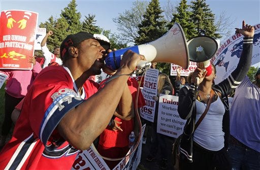 CORRECTS TO SAY SECOND NATIONAL CONVENTION INSTEAD OF FIRST - FILE - In this May 22, 2014 file photo, protesters gather outside of the McDonald's Corporation headquarters in Oak Brook, Ill., the annual shareholders meeting demonstrating for higher wages and the right to unionize. On Friday, July 25, 2014, in Chicago, organizers are holding the second national convention of fast-food workers. Theyâ€™ll be discussing how to move forward with the protests and other actions calling for higher wages that have been taking place in cities around the country since late 2012.Â  (AP Photo/M. Spencer Green, File)
