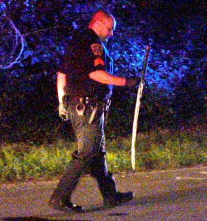 A Bourne police officer carries a samurai sword allegedly used in a stabbing.