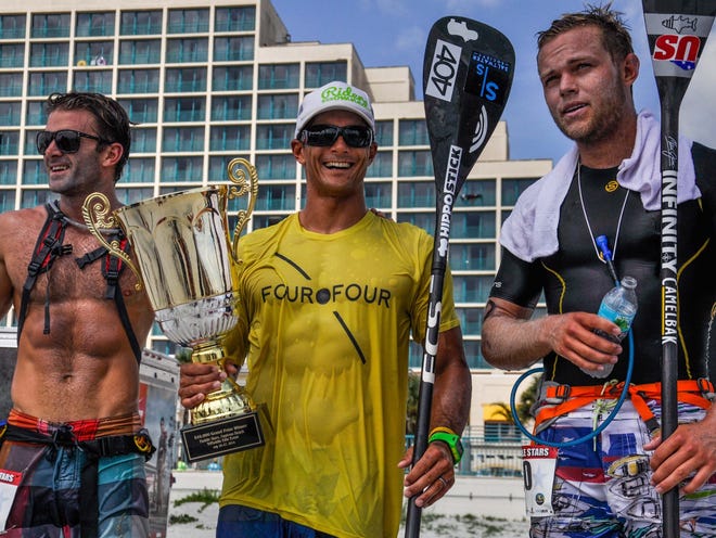 From left, Billy Miller (2nd place), Danny Ching (1st place) and Slater Trout (3rd place), gather after the Paddle Stars competition at Daytona Beach on Sunday, July 27, 2014.