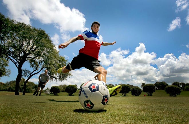 ZACK SHRIVER KICKS A BALL off the tee box while playing footgolf at the largo golf course on Wednesday. the sport, which is akin to golf but played with soccer balls, has brought in a new demographic and more revenue. (ERNST PETERS | THE LEDGER)