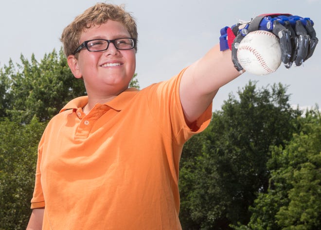 Kaeden Witt (photographed Saturday, July 19, 2014, at his home in Machesney Park) is the second child to receive a prosthetic hand from engineering students at Boylan Catholic High School.