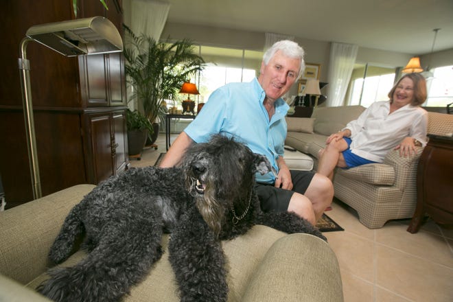 Frank Catalano and Lina Beth Catalano spend a moment with their Kerry Blue Terrier Finian in their Stone Creek home in Ocala, Florida on Monday July 28, 2014. Frank had to give up Finian and his other Kerry Blue due to a family situation. Lina Beth encouraged him to get them both back but only Finian was available.