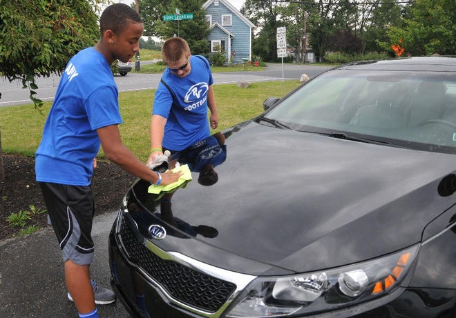 Freshman Michael Brown, left, and junior, Vincent David, put the finishing touches on a car during the Pleasant Valley football teme’s car wash on Sunday at West End Physical Therapy in Kresgeville. The footbal team has another fundraiser, a breakfast buffet from 9 a.m. to noon onSaturday at Kinsley’s ShopRite. Cost of tickets is $8.