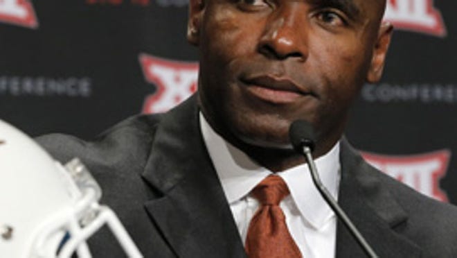 University of Texas coach Charlie Strong talks with reporters at the Big 12 Media Days at the Omni Dallas Hotel, Tuesday, July 22, 2014, in Dallas.