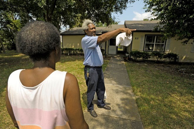 Resident Donald Simmons talks with a woman concerned about her mother who also lives at the Senior Citizen Village Monday afternoon after some of the residents were issued Order To Vacate notices. Water issues in the back of the complex were resolved Tuesday and residents were able to move back in.