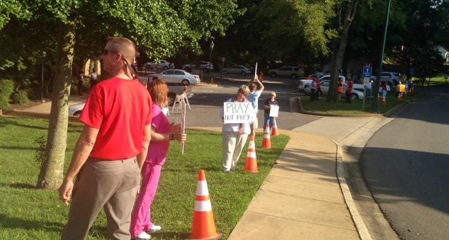 Protesters stand outside Kings Mountain City Hall Tuesday night prior to the scheduled city council meeting.