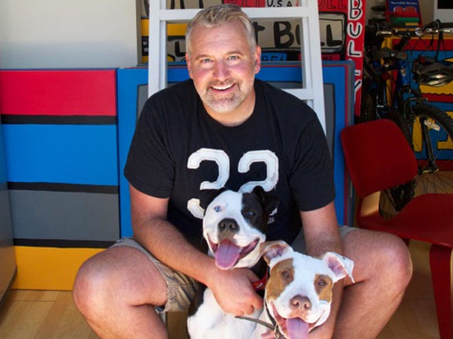 This 2013 photo released by Todd Parr shows children's book author Parr with his dogs Pete, left, and tater Tot in Berkeley, Calif. Parr, 52, relies on playful, brightly-colored drawings and easy-to-understand messages to win over the age 4-to-6 set, along with their teachers and parents.