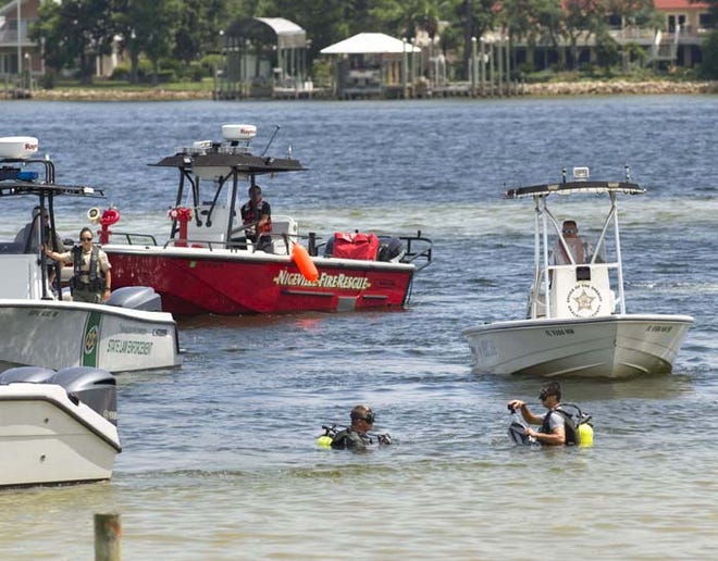 Divers with the Okaloosa County Sheriff's Office search an area of Choctawhatchee Bay near Garnier's Beach Park Tuesday for a 4-year-old boy.