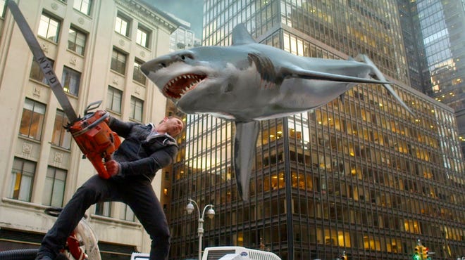 Ian Ziering, as Fin Shepard, battles a shark on a New York City street in "Sharknado 2: The Second One." (THE ASSOCIATED PRESS)