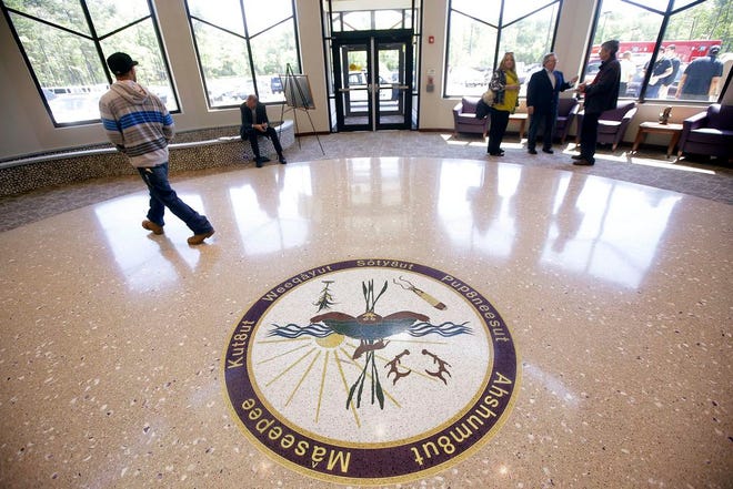 People move through the lobby of the newly constructed Mashpee Wampanoag Tribe's Community/Government Center in Mashpee.