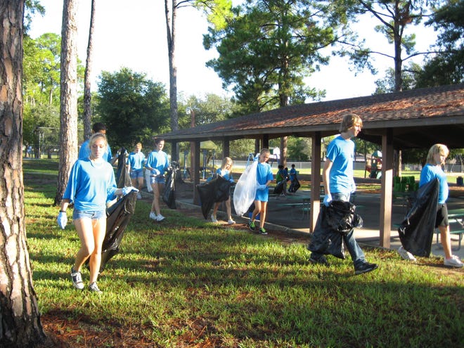 Students from Matanzas High School’s environmental science academy fan out to pick up trash in James Holland Park in Palm Coast as part of the city’s Intracoastal cleanup event in 2011.
