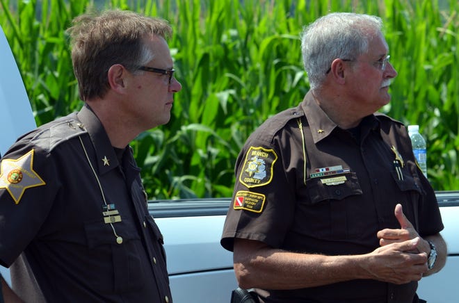 Steuben County, Indiana sheriff Tim Troyer and Branch County sheriff John Pollack confer at the scene of the armed stand off last Tuesday. DON REID PHOTO