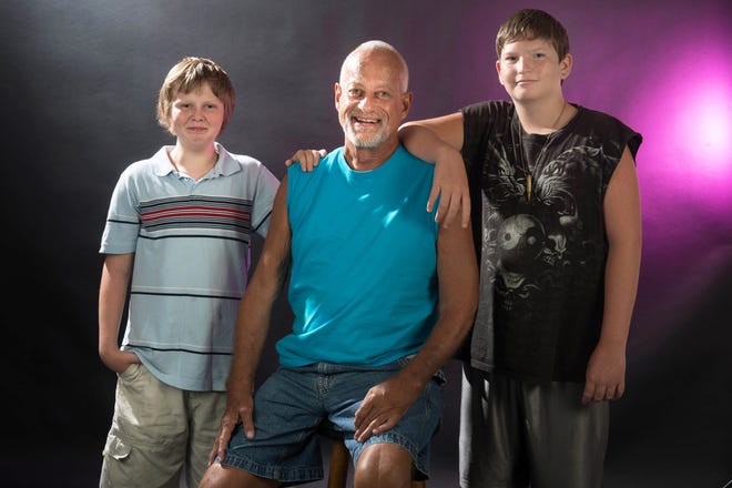 James "Jimmy" Adams poses with his sons, Zachary, 12, left, and James, 14.