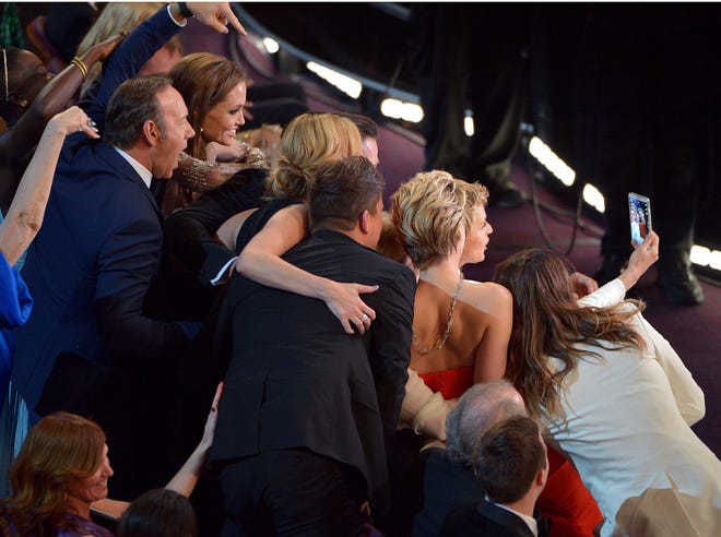 FILE - This March 2, 2014 file photo shows Kevin Spacey, from left, Angelina Jolie, Julia Roberts, Brad Pitt, Jennifer Lawrence, Ellen Degeneres and Jared Leto join other celebrities for a group selfie during the Oscars at the Dolby Theatre in Los Angeles. (Photo by John Shearer/Invision/AP, File) ORG XMIT: NYET216