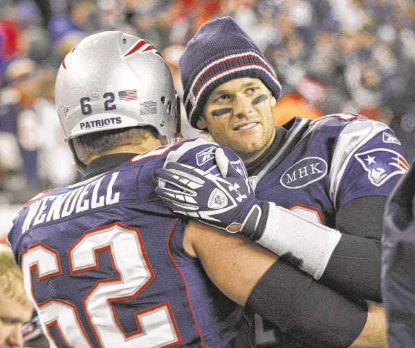 New England Patriots quarterback Tom Brady hugs teammate Ryan Wendell following their NFL divisional playoff football game against the Denver Broncos Saturday, Jan. 14, 2012, in Foxborough, Mass. The Patriots defeated the Broncos 45-10.