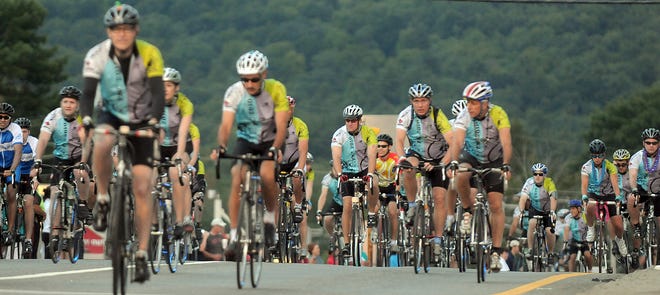 FILE - In this Aug. 7, 2010 file photo, bicycle riders leave Sturbridge, Mass., along U.S. Route 20 at the start of the Pan-Mass Challenge. The annual 190-mile event from Sturbridge to Provincetown, to raise money for cancer research and treatment, is scheduled for Aug. 2-3, 2014.