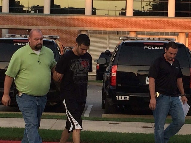 Times Record File Photo / Fort Smith police officials escort Douglas True, 21, to the Sebastian County Adult Detention Center on Sunday, July 20, 2014. True is charged with capital murder in the death of his pregnant girlfriend, Briana Butler, 22.
