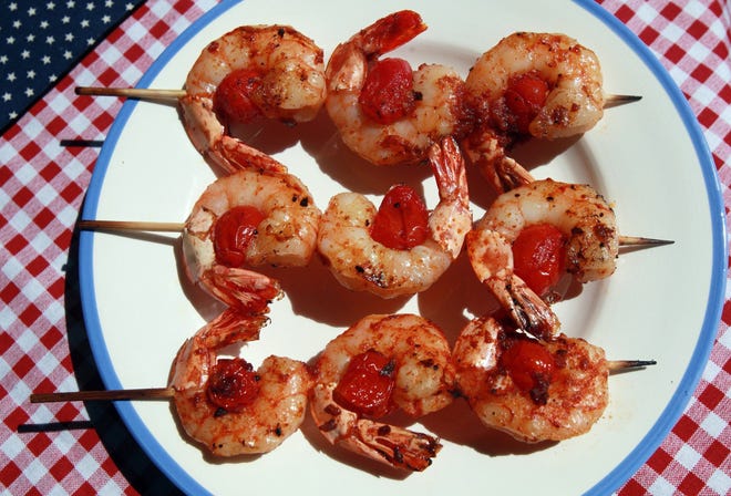 Skewering shrimp on the grill, such as these shrimp and sausage skewers with smoky paprika glaze, prevents the risk of losing a shrimp through the grates, as well as ensuring they cook evenly.