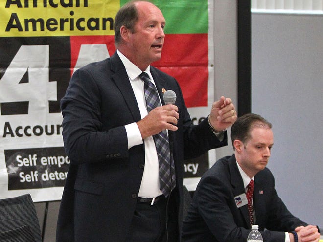 In this July 7, 2014 file photo, U.S. Rep. Ted Yoho, left, and Jake Rush, his Republican challenger, attend a forum in Gainesville.