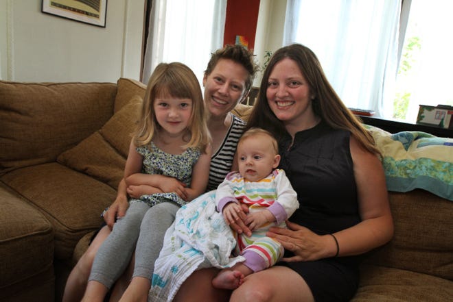Rebecca Karb, left, and Clare Cecil-Karb with their daughters, 3-year-old Tess and 3-month-old Ellie. The couple, who live in Providence, deliberately moved to a state that recognized the vows they made in Massachusetts in 2008.