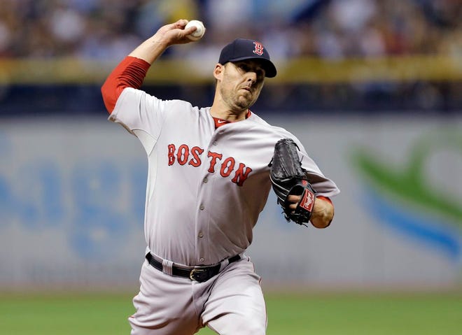 Boston Red Sox starting pitcher John Lackey delivers to the Tampa Bay Rays during the first inning of a baseball game Saturday, July 26, 2014, in St. Petersburg, Fla. (AP Photo/Chris O'Meara)