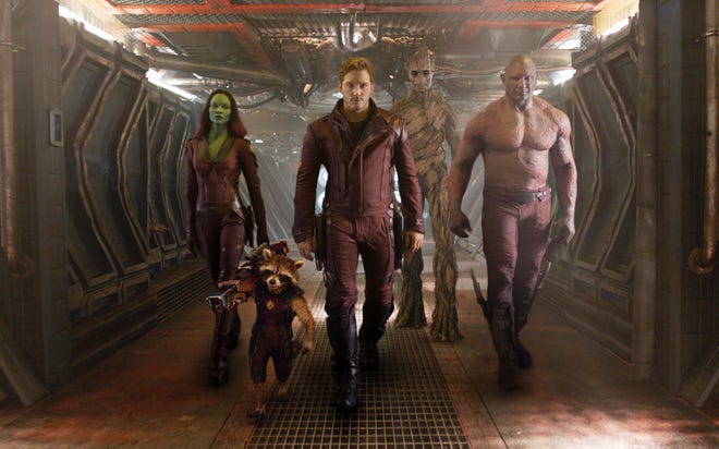 This image released by Disney - Marvel shows, from left, Zoe Saldana, the character Rocket Racoon, voiced by Bradley Cooper, Chris Pratt, the character Groot, voiced by Vin Diesel and Dave Bautista in a scene from "Guardians Of The Galaxy"