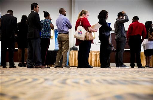 Job seekers wait in line to meet with recruiters during a June 23 job fair in Philadelphia. The United States experienced its sixth straight month in July of job growth above 200,000.