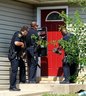 Columbia police make entry into a home at 4208 Bold Venture Drive Thursday July 31, 2014. Police were called to the home after a report of a disturbance.
