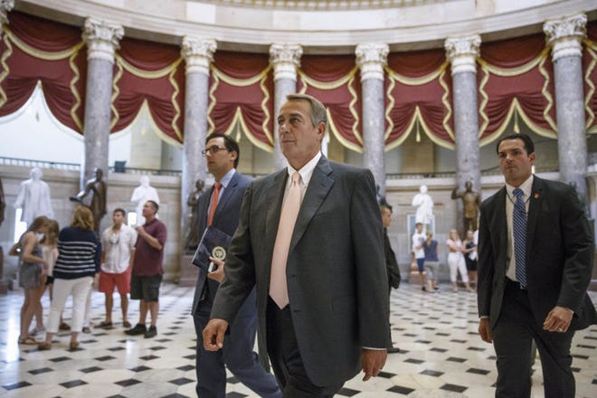 House Speaker John Boehner of Ohio strides to the House chamber on Capitol Hill in Washington, Wednesday, July 30, 2014, as lawmakers prepare to move on legislation authorizing an election-year lawsuit against President Barack Obama that accuses him of exceeding his powers in enforcing his health care law. Democrats have branded the effort a political charade aimed at stirring up Republican voters for the fall congressional elections. They say it's also an effort by top Republicans to mollify conservatives who want Obama to be impeached — something Boehner said Tuesday he has no plans to do. (AP Photo/J. Scott Applewhite)