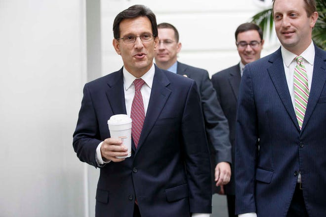 House Majority Leader Eric Cantor of Va., left, arrives for a House Republican strategy session on Capitol Hill in Washington, Tuesday, July 29, 2014. As a result of his defeat in the Virginia primary, Cantor will relinquish his leadership post at the end of the week. (AP Photo/J. Scott Applewhite)