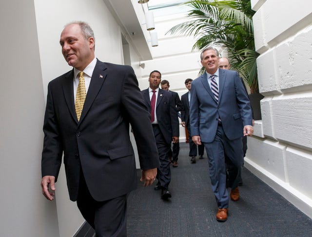 THE ASSOCIATED PRESS / House Majority Whip Steve Scalise of La., left, House Majority Leader Kevin McCarthy of Calif., right, and others, arrive for a closed-door meeting of House Republicans on Capitol Hill in Washington, Friday, Aug. 1, 2014, to deal with the border crisis, a day after Congress was supposed to go into its August recess. Yesterday, as the House gathered for the planned vote to fund resources for the immigration crisis on the U.S.-Mexico border, the roll call was scrapped by conservatives in the Republican ranks. (AP Photo/J. Scott Applewhite)