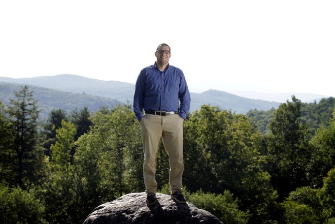 John DosSantos, formerly of Saunderstown, now lives and works in Vermont, where he is a financial administrator for the state. DosSantos is pictured near his office in Montpelier. Behind him are the Green Mountains.