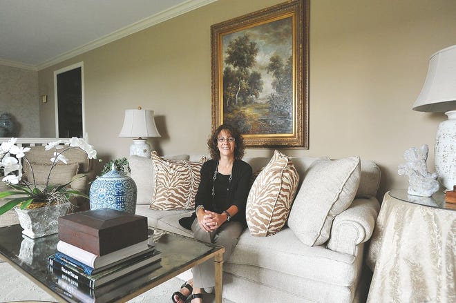 Interior designer Laurie Brown of Dover sits in the living room of home that she recently designed.