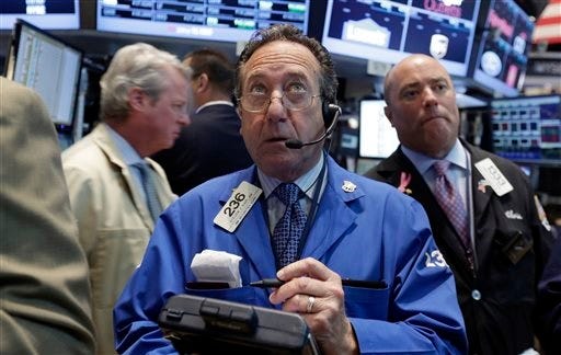 Trader Steven Kaplan, center, works on the floor of the New York Stock Exchange, Monday, Aug. 4, 2014. U.S. stocks are opening mostly higher as the market recovers from a two-day slide last week. (AP Photo/Richard Drew)