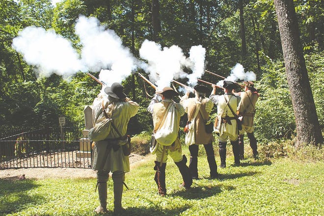 Members of the Kittochtinny Associators, 1700s pre-militia re-enactors, offered a volley Saturday during the memorial service for Enoch Brown and his 10 students who were massacred by Indians in 1764. A wreath was placed at the site of the mass grave at Enoch Brown Park in Antrim Township.