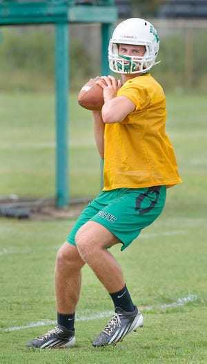 Choctaw quarterback Quint Gornto drops back before throwing a pass during Monday's practice.