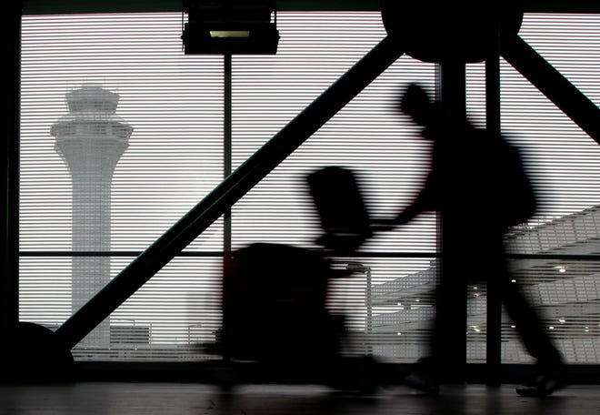 In this Dec. 21, 2013 file photo, a traveler walks through Terminal 3 at O'Hare International Airport in Chicago. Airfare is up 10.7 percent in the past five years - after adjusting for inflation - according to an Associated Press analysis of data from the Airlines Reporting Corp.