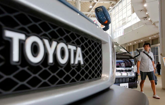 A visitor walks around a Toyota showroom in Tokyo. Toyota Motor Corp. reported a better-than-expected rise in quarterly profit as vehicle sales grew in North America and Europe, offsetting a drop in Japan.
