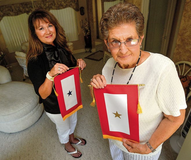 Patti Smith, left, President and Founder of Central Illinois Gold Star Families, stands with Dolores Reatherford of Peoria, recipient of a Gold Star when her son died in the Vietnam War in 1969.