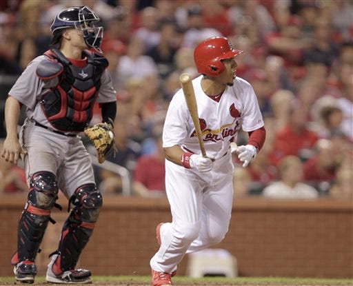 St. Louis Cardinals' Jon Jay (19) follows through on an RBI single in front of Boston Red Sox catcher Christian Vazquez during the eighth inning of a baseball game, Tuesday, Aug. 5, 2014, in St. Louis. The Cardinals beat the Red Sox 3-2. (AP Photo/Tom Gannam)