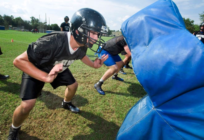 Stephen Merrifield and other members of the Rocky Bayou Christian School football team work out Tuesday, on the second day of football practice. Aug. 5, 2014.