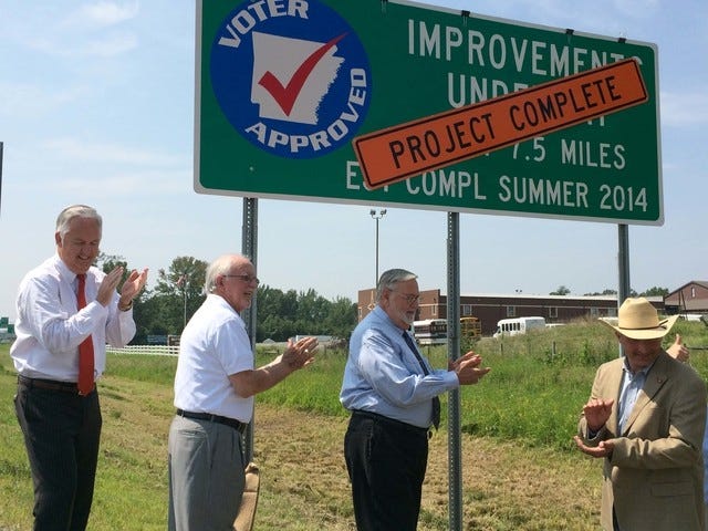 Justin Bates Times Record / Fort Smith City Administrator Ray Gosack, left, Arkansas Highway Commissioner, second from left, Fort Smith Mayor Sandy Sanders, center, and State Sen. Bruce Holland, R-Greenwood, right, celebrate on Tuesday the completion of construction work on 71/2 miles of roadway between Van Buren and Fort Smith. Construction on the $78.8 million project began in January 2013. 
 Justin Bates Times Record / A vehicle travels past a project completion sign along Interstate 540 between Van Buren and Fort Smith. Local, state and highway dignitaries gathered Tuesday to recognize the completion of the 71/2 mile, $78.8 million project. 
 Justin Bates Times Record / Fort Smith City Administrator Ray Gosack, left, Arkansas Highway Commissioner, second from left, Fort Smith Mayor Sandy Sanders, center, and State Sen. Bruce Holland, R-Greenwood, right, unveil a sign on Tuesday recognizing the completion of construction work on 71/2 miles of roadway between Van Buren and Fort Smith. Construction on the $78.8 million project began in January 2013. 
 Justin Bates Times Record / Fort Smith City Administrator Ray Gosack, left, listens as Arkansas Highway Commissioner, second from left speaks Tuesday at a ceremony recognizing the completion of construction work on 71/2 miles of roadway between Van Buren and Fort Smith. Construction on the $78.8 million project began in January 2013. Also pictured are Fort Smith Mayor Sandy Sanders, center, State Sen. Bruce Holland, R-Greenwood, right, and Van Buren Mayor Bob Freeman, far right.