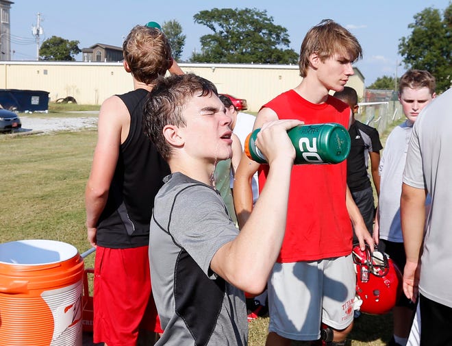 Holy Spirit football player Searcy Elebash takes a break to hydrate during practice Tuesday.