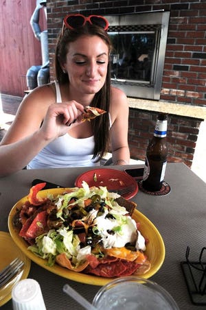 Lauren Doucet, 24, of Hanson has a meal at the Abington Ale House & Grill on Monday.