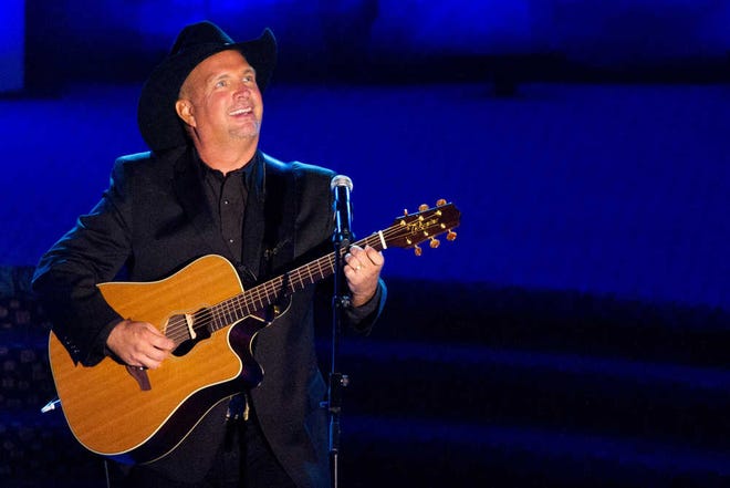 FILE - This June 16, 2011 file photo shows inductee Garth Brooks performing onstage at the 42nd Annual Songwriters Hall of Fame Awards in New York. In stores Thursday, Nov. 28, 2013, is Brook's "Blame It All On My Roots," eight-disc box set containing a blast of newly recorded material. Brooks heads up a concert special Friday, Nov. 29, 2013, that CBS will broadcast live from the Wynn resort in Las Vegas.(AP Photo/Charles Sykes, File)