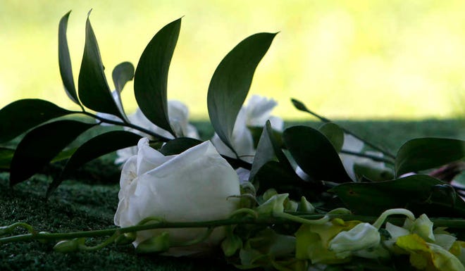 A white rose rests on the grave of Cooper Harris at the Tuscaloosa Memorial Park Cemetery on Saturday, June 28, 2014, in Tuscaloosa, Ala. (AP Photo/Butch Dill)