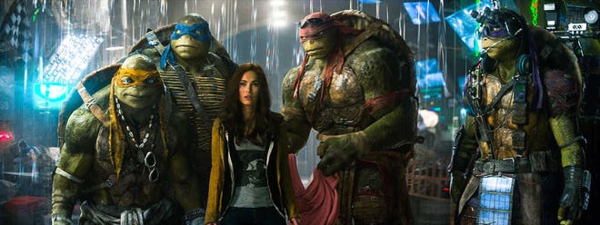 This image released by Paramount Pictures shows, from left, Michelangelo, Leonardo, Megan Fox, as April O'Neil, Raphael, and Donatello in a scene from "Teenage Mutant Ninja Turtles." (AP Photo/Paramount Pictures, Industrial Light & Magic)